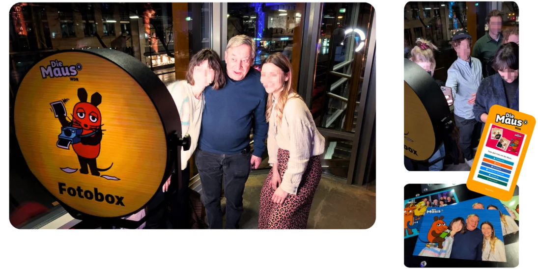 Eine Gruppe von Personen posiert für ein Foto vor einer Fotobox mit dem Logo "Die Maus" bei einem Get-together-Event.